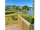 Expansive lake view from the wooden deck with lush landscaping and clear blue skies at 203 Sea Marsh Ct, Fayetteville, GA 30215