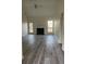 Bright living room with fireplace and backyard access features stylish flooring and ample space at 203 Sea Marsh Ct, Fayetteville, GA 30215