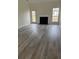 Bright living room features a cozy fireplace and large windows with views of the backyard at 203 Sea Marsh Ct, Fayetteville, GA 30215