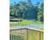 Enjoy the outdoor view of the tennis courts and playground from the deck at 203 Sea Marsh Ct, Fayetteville, GA 30215