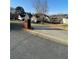 Street view of home featuring lush greenery, mature trees, and a charming mailbox at 203 Sea Marsh Ct, Fayetteville, GA 30215