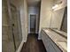 Modern bathroom featuring double sinks, marble countertops, and a glass door shower at 333 Darlington Dr, Ellenwood, GA 30294