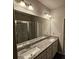 Bathroom with granite countertops, double sinks, and modern lighting at 333 Darlington Dr, Ellenwood, GA 30294