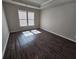 Bright bedroom with wood-look flooring, abundant natural light, and tray ceiling at 333 Darlington Dr, Ellenwood, GA 30294
