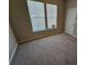 Spacious bedroom with neutral walls and carpet, brightened by natural light from two large windows at 333 Darlington Dr, Ellenwood, GA 30294