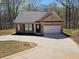 Charming brick home featuring an attached garage and a long driveway for ample parking at 333 Darlington Dr, Ellenwood, GA 30294