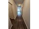 Hallway with neutral paint leads to a living room with ceiling fan and a fireplace at 333 Darlington Dr, Ellenwood, GA 30294