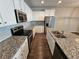 Bright kitchen with white cabinets, granite countertops, stainless steel appliances, and hard surface floors at 333 Darlington Dr, Ellenwood, GA 30294