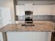 Modern kitchen showcasing stainless steel appliances, granite countertops, and tiled backsplash at 333 Darlington Dr, Ellenwood, GA 30294