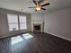 Comfortable living room with dark wood floors, fireplace, and ceiling fan at 333 Darlington Dr, Ellenwood, GA 30294