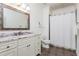 Bathroom with marble vanity, tile floors and shower-tub combination with white shower curtain at 425 Prestwick Ct, Alpharetta, GA 30005