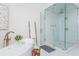 Modern bathroom with soaking tub, glass shower with white marble tile and rain shower head, and wood ladder at 425 Prestwick Ct, Alpharetta, GA 30005