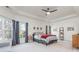 Spacious bedroom features neutral decor, tray ceiling, and large windows for natural light at 425 Prestwick Ct, Alpharetta, GA 30005