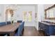 Elegant dining room with modern chandelier, wainscoting, hardwood floors, and a blue accent table at 425 Prestwick Ct, Alpharetta, GA 30005