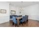 Elegant dining room with modern chandelier, wainscoting, and hardwood floors at 425 Prestwick Ct, Alpharetta, GA 30005