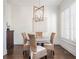 Bright dining room features modern decor, including an eye-catching chandelier and shuttered windows at 425 Prestwick Ct, Alpharetta, GA 30005