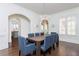 Elegant dining room with modern chandelier, wainscoting, hardwood floors, and view to the kitchen at 425 Prestwick Ct, Alpharetta, GA 30005