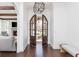 Bright entryway with dark wood floors, arched double doors, and a view of the living room at 425 Prestwick Ct, Alpharetta, GA 30005