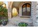 Close up of the brick arched entryway with brick stairs and double wooden front doors at 425 Prestwick Ct, Alpharetta, GA 30005