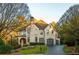 Beautiful two-story brick home with arched entryway, lush landscaping, and a two-car garage at 425 Prestwick Ct, Alpharetta, GA 30005