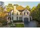 Beautiful two-story brick home with a manicured lawn, arched entryway, and attached two-car garage at 425 Prestwick Ct, Alpharetta, GA 30005