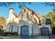 Brick home featuring attached garage with lush front yard and mature trees at 425 Prestwick Ct, Alpharetta, GA 30005