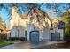 Home with attached three-car garage and brick exterior with manicured front yard at 425 Prestwick Ct, Alpharetta, GA 30005