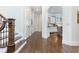 Hallway view leading to a bright kitchen with white cabinetry and stainless steel appliances at 425 Prestwick Ct, Alpharetta, GA 30005