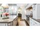 Well-appointed kitchen features granite countertops, stainless steel appliances and custom white cabinetry at 425 Prestwick Ct, Alpharetta, GA 30005