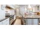 Gourmet kitchen with stainless steel appliances, granite countertops, large island, and custom cabinetry at 425 Prestwick Ct, Alpharetta, GA 30005