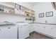 Laundry room features white washer and dryer, ample storage, and a sink at 425 Prestwick Ct, Alpharetta, GA 30005