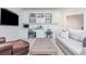 Comfortable living room with built-in shelving, desk space, and a large flatscreen television at 425 Prestwick Ct, Alpharetta, GA 30005