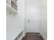 White mud room features bench seating and hooks with storage and a dark wood floor at 425 Prestwick Ct, Alpharetta, GA 30005