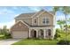 Charming two-story home with a brick-and-siding exterior, a covered porch, and a well-manicured lawn at 5250 Trescott Path, Cumming, GA 30028