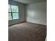 Bedroom featuring neutral carpet, a window, and white walls at 10303 Waldrop Place, Decatur, GA 30034