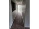 Hallway featuring neutral carpet and a partial wall offering a view into another room at 10303 Waldrop Place, Decatur, GA 30034