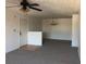 Spacious living room with carpet, ceiling fan, and a dining area with modern chandelier at 10303 Waldrop Place, Decatur, GA 30034