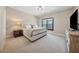 Comfortable bedroom featuring soft lighting, a plush bed, and a wooden dresser with ample space for storage at 13415 Bishops Ct, Roswell, GA 30075