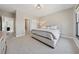 Serene bedroom with a tufted headboard, a plush bed, and soft lighting from the bedside table lamp at 13415 Bishops Ct, Roswell, GA 30075