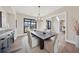 Stylish dining room with hardwood floors, black table, and beige upholstered chairs at 13415 Bishops Ct, Roswell, GA 30075