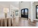 Elegant entryway features wood floors, black double doors, and a view of the dining area at 13415 Bishops Ct, Roswell, GA 30075