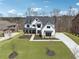 Charming white home with a black roof, well-manicured lawn and landscaping at 13415 Bishops Ct, Roswell, GA 30075