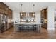 Gourmet kitchen with large island, pendant lights, stainless steel appliances, and modern cabinetry at 13415 Bishops Ct, Roswell, GA 30075