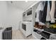 Well-organized laundry room with shelving and appliances at 13415 Bishops Ct, Roswell, GA 30075