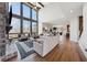 Bright living room boasts floor to ceiling windows, hardwood floors, and a stone fireplace at 13415 Bishops Ct, Roswell, GA 30075