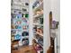 Walk-in pantry with custom shelving providing ample storage for groceries and kitchen essentials at 13415 Bishops Ct, Roswell, GA 30075