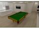 Spacious game room featuring a pool table, modern lighting, and sleek flooring at 13415 Bishops Ct, Roswell, GA 30075