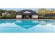 Community swimming pool with clear, refreshing water and a nearby bath house at 13415 Bishops Ct, Roswell, GA 30075
