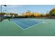 View of the community tennis courts and professional lighting and fencing at 13415 Bishops Ct, Roswell, GA 30075