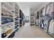 Spacious walk-in closet with custom shelving, hanging rods, and ample storage for clothes, shoes, and accessories at 13415 Bishops Ct, Roswell, GA 30075